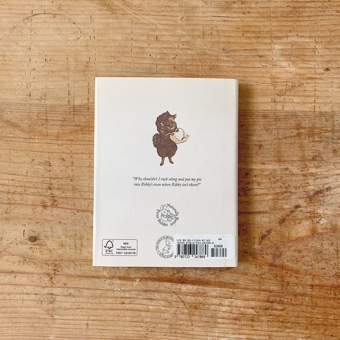 The back cover of the book with an illustration of an animal holding a basket, shown on a wooden surface