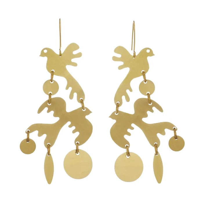 Pair of Sibilia Two Little Birds Earrings, featuring two stacked matte gold brass bird silhouettes with organic branch-like cutouts, with dangling small round disc and leaf-shaped charms at the bottom, on gold wire hooks, on a white background