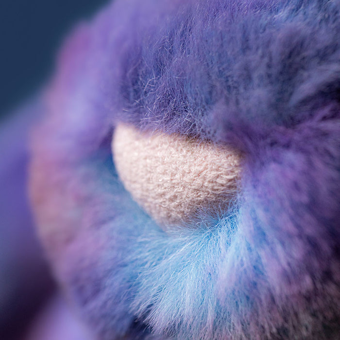 Close-up of a fluffy purple and blue bunny nose with a pink center.