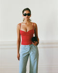 Women's singlet top in deep red colour featuring figure-hugging fit, contoured waist, and bust gathering.